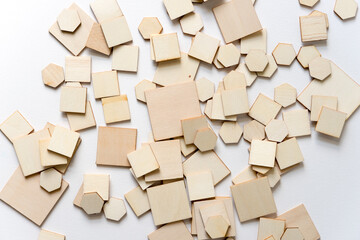 scattered wooden shapes on a white background