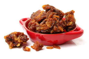 brown raisins on a white background