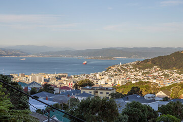Fototapeta na wymiar Wellington, New Zealand - January 29, 2018: Boats and cargo ship arriving at Wellington, New Zealand