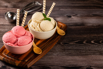 Bowls with strawberry and vanilla ice cream.