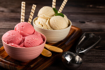 Bowls with strawberry and vanilla ice cream.