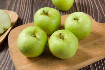 Ripe green apples on table
