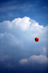 A colorful balloon yearning for freedom in the clear sky