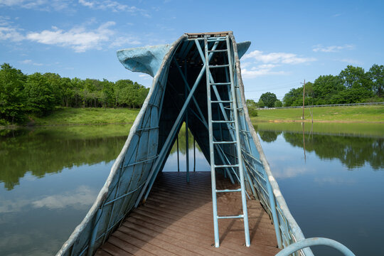 Catoosa, Oklahoma - May 5, 2021: The famous road side attraction Blue Whale of Catoosa along historic Route 66. View of the old ladder from the waterslide