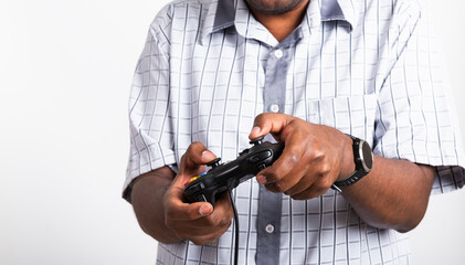 Fototapeta premium Asian happy portrait young black man funny use hand playing video game pad joystick controller, studio shot isolated on white background