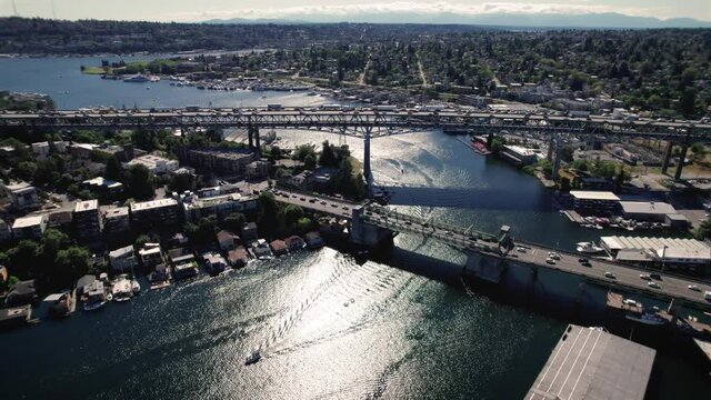 Breathtaking Aerial View of Seattle Commuters Crossing Bridge with Boat Traveling Under