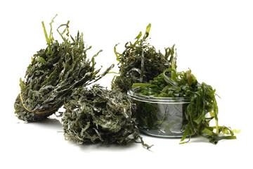 dried, chopped, green seaweed on white background 