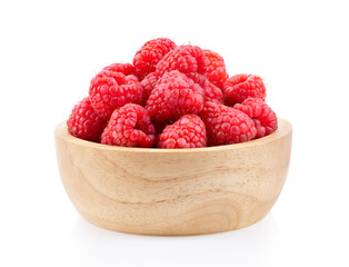 Raspberry in wood bowl  isolated on white