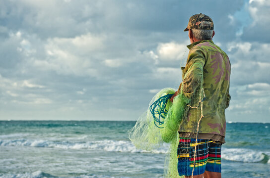 Old men fishing with a web in Guanabo beach