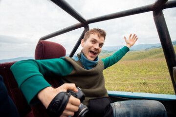Happy man traveler photograph on background of extreme ATV. Concept car travel safari park tour in Africa summer © Parilov