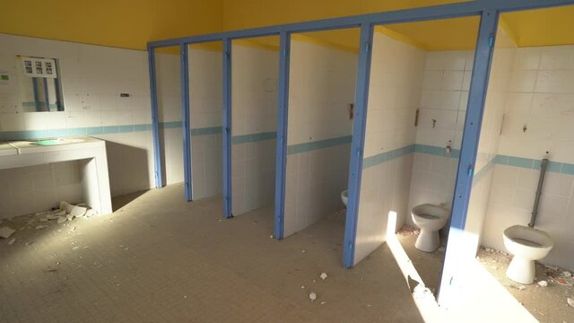 Abandoned public bathroom in a soon to be demolished school