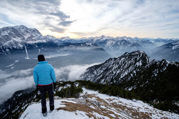 Wanderin bestaunt das Panorama der schneebedeckten Alpen