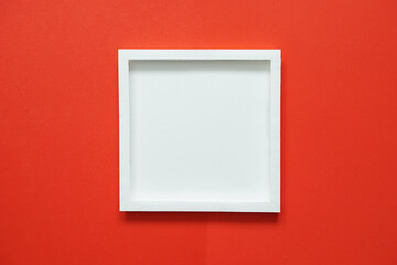 blank white square frame on red background.