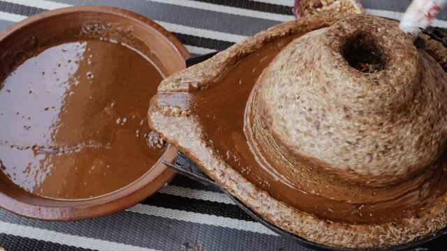 Traditional Moroccan millstone, grinding stone, where Argan kernels are ground. The paste will be used to extract the famous Argan oil. The oil is used in cooking and cosmetics. 
