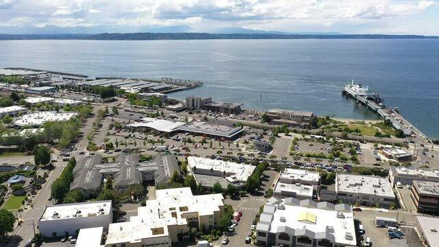 Cinematic 4K drone footage of the downtown Edmonds commercial area, Kingston ferry terminal, Port of Edmonds, waterfront marina, near Seattle in the Pacific Northwest, in Snohomish County
