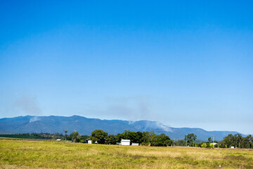 Smoke in the forest covered hills on the Atherton Tableland in Queensland, Australia
