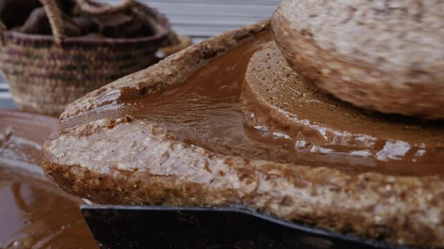 Closeup of Argan kernels, that are ground with a traditional Moroccan millstone, grinding stone. The paste will be used to extract the famous Argan oil. 