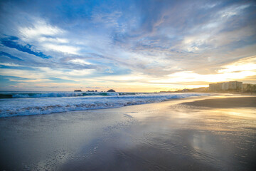 landscape with sea sunset on beach, clouds, sun and island.
Beautiful sunrise over the sea, people walking,Panorama of Beach, Ocean, People