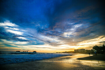 Fototapeta na wymiar landscape with sea sunset on beach, clouds, sun and island. Beautiful sunrise over the sea, people walking,Panorama of Beach, Ocean, People