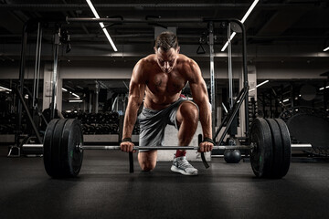 Fototapeta Athlete, man doing deadlift with a barbell young athlete preparing for a heavy weight barbell lifting workout obraz