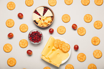 Tasty crackers and snacks on white background