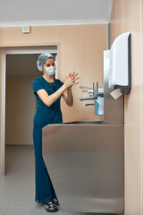 woman surgeon, washes her hands in the preoperative unit, the surgeon disinfects his hands before the operation.