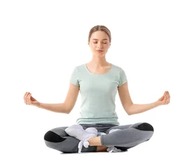  Sporty young woman meditating on white background © Pixel-Shot