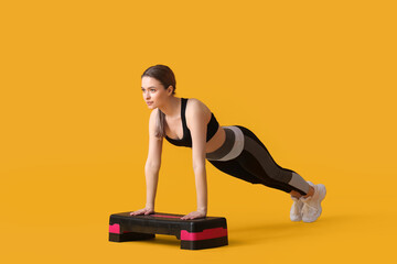 Sporty young woman training on color background