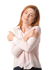 Happy woman hugging herself on white background