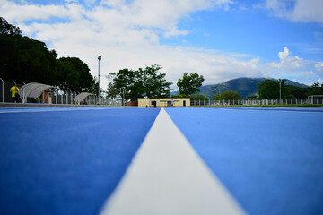 blue running track with a white line in the center