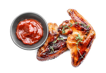 Roasted chicken wings and sauce on white background