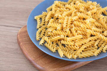 Whole wheat uncooked spaghetti on a plate