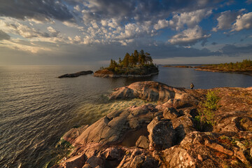 Photographer on the shore of the island in the early sunny morning