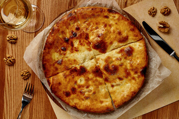 Sliced Megrelian khachapuri with walnuts and white wine