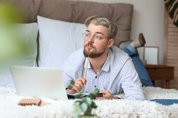 Young man studying online at home