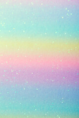 Iridescent paper surface with glitter. Abstract blurred multi-colored pastel background with sequins