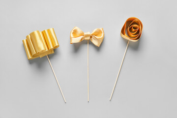 Composition with beautiful golden ribbons on light background