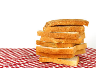 sliced bread on red checked tablecloth background