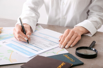 Woman applying travel insurance form in office