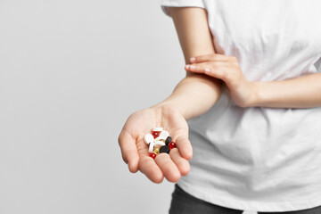 woman holding multicolored pills in palm pharmacy medicine