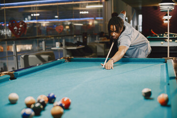 Man playing billiards in a club