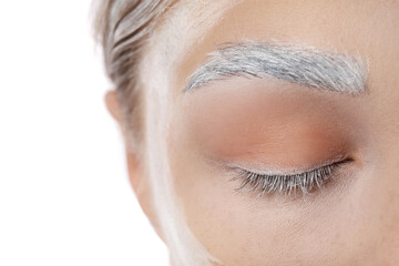 Young woman with dyed eyebrow on white background