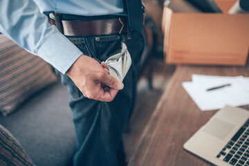 Office worker lost his job in jeans show empty pocket without money. Empty wallet, empty pocket, fail bank concept.