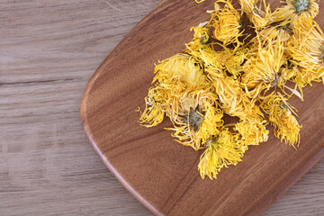 Golden chrysanthemum tea on cutting board