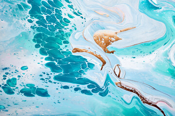 Acrylic Fluid Art. Waves in mint turquoise colors with liquid golden inclusion. Abstract marble background or texture