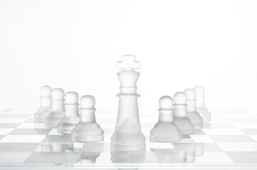 king chess pieces on a glass chessboard 