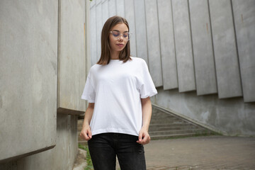 Girl or woman wearing white blank t-shirt with space for your logo, mock up or design in casual...