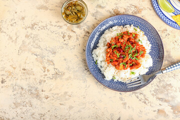 Plate with tasty chili con carne, rice and pickled jalapeno on color background