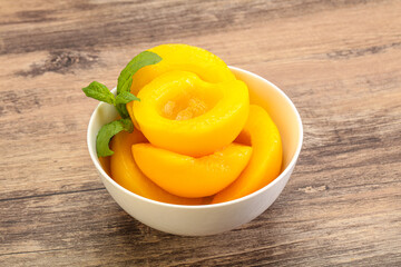 Sweet ripe canned peaches with mint