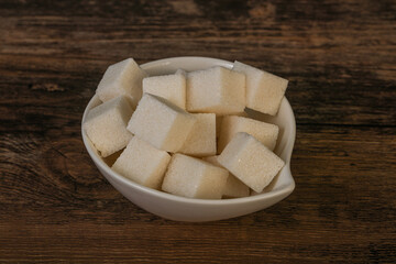 Refined white sugar cubs in the bowl